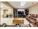 Finished basement featuring a cozy seating area, entertainment center, and large comfortable brown leather couches at 1018 Jubilee Way, Powder Springs, GA 30127
