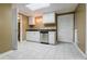 This basement kitchen features stainless steel appliances, white cabinets, and a tiled floor at 1018 Jubilee Way, Powder Springs, GA 30127