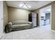 View of basement features tile flooring, a refrigerator and a comfortable sofa at 1018 Jubilee Way, Powder Springs, GA 30127
