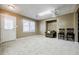 Finished basement with a cozy seating area with an armchair and access to the backyard through a white door at 1018 Jubilee Way, Powder Springs, GA 30127