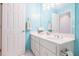 Bright bathroom with a double sink vanity, large mirror, and blue accent walls at 1018 Jubilee Way, Powder Springs, GA 30127