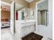 Bathroom featuring a white vanity with a sink, a large mirror, and views of a bedroom and another room at 1018 Jubilee Way, Powder Springs, GA 30127