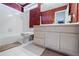 Bathroom featuring a shower-tub combination, red accent wall, and white tile floors at 1018 Jubilee Way, Powder Springs, GA 30127