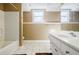 Bathroom featuring a white vanity with drawers, a bathtub, and a window for lots of light at 1018 Jubilee Way, Powder Springs, GA 30127