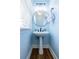 Powder room featuring a pedestal sink, round mirror, and modern lighting fixture at 1018 Jubilee Way, Powder Springs, GA 30127