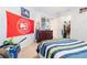 Sports-themed bedroom with Atlanta Hawks memorabilia and a blue/green striped bedspread at 1018 Jubilee Way, Powder Springs, GA 30127
