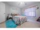 Cozy bedroom with plush blue rug, charming decor, and ample natural light at 1018 Jubilee Way, Powder Springs, GA 30127