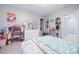 Playful bedroom featuring colorful decor, a dollhouse, and plenty of storage space for toys at 1018 Jubilee Way, Powder Springs, GA 30127