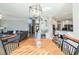 Open concept dining room with modern lighting and views into the living room and kitchen at 1018 Jubilee Way, Powder Springs, GA 30127
