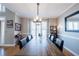 Formal dining room featuring a large wooden table, chandelier, and stylish decor at 1018 Jubilee Way, Powder Springs, GA 30127