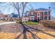Charming brick home with a two-car garage and mature trees, offering a picturesque curb appeal at 1018 Jubilee Way, Powder Springs, GA 30127