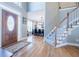 Grand foyer with hardwood floors, staircase, and views to the dining room creates an elegant entrance at 1018 Jubilee Way, Powder Springs, GA 30127