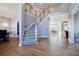 Bright foyer with staircase and hardwood floors leading to dining and living areas at 1018 Jubilee Way, Powder Springs, GA 30127