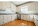 Stylish kitchen showcasing white cabinets, granite countertops, and stainless steel appliances at 1018 Jubilee Way, Powder Springs, GA 30127