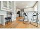 Kitchen with breakfast bar, white cabinets, and hardwood floors leading into dining area at 1018 Jubilee Way, Powder Springs, GA 30127