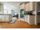 Spacious kitchen with stainless steel appliances and hardwood floors, opens to living area at 1018 Jubilee Way, Powder Springs, GA 30127