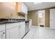Kitchenette features white cabinets, a stainless steel dishwasher, and granite countertops at 1018 Jubilee Way, Powder Springs, GA 30127