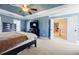 Spacious main bedroom with tray ceiling, ceiling fan, and doorway to another room or hallway at 1018 Jubilee Way, Powder Springs, GA 30127