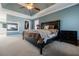 Large main bedroom with a tray ceiling, a fireplace, and an attached closet and bathroom at 1018 Jubilee Way, Powder Springs, GA 30127