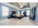 Spacious main bedroom featuring a tray ceiling, fan, and ample natural light at 1018 Jubilee Way, Powder Springs, GA 30127