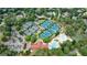 Stunning aerial view of the community amenities, including tennis courts, pool, and clubhouse surrounded by lush greenery at 2616 Boddie Pl, Duluth, GA 30097