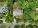 Aerial view of landscaped property with circular drive and lush green trees at 2616 Boddie Pl, Duluth, GA 30097