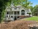 Home's backyard features a covered patio, stone walkway, rock accents, and a green lawn at 2616 Boddie Pl, Duluth, GA 30097