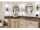 Bathroom featuring double sinks with marble countertops, decorative lighting fixtures, and white cabinetry at 2616 Boddie Pl, Duluth, GA 30097
