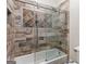 Bathroom features a stylish glass enclosed tiled shower over tub combination with tile accents at 2616 Boddie Pl, Duluth, GA 30097