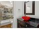 This stylish bathroom boasts a modern vanity with a unique sink and a glass-enclosed shower over tub at 2616 Boddie Pl, Duluth, GA 30097