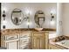 Bathroom featuring double sinks with marble countertops, decorative lighting fixtures, and white cabinetry at 2616 Boddie Pl, Duluth, GA 30097