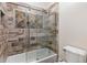 Detailed bathroom showcasing tiled shower with sliding door, as well as a toilet at 2616 Boddie Pl, Duluth, GA 30097