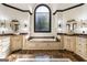 Elegant bathroom features dual sinks, marble countertops, a soaking tub, and an arched window at 2616 Boddie Pl, Duluth, GA 30097