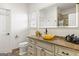 A bathroom with a yellow vessel sink and a well-lit mirror above the granite countertop at 2616 Boddie Pl, Duluth, GA 30097