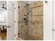 Walk in shower with detailed neutral tile, black shower fixtures and glass door at 2616 Boddie Pl, Duluth, GA 30097