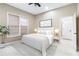 This light and airy main bedroom has a neutral palette, a large window, and ceiling fan at 2616 Boddie Pl, Duluth, GA 30097
