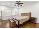 A well-lit bedroom boasts hardwood floors, large windows, and decorative patterned bedding at 2616 Boddie Pl, Duluth, GA 30097