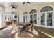 Inviting covered patio with comfortable wicker furniture, ceiling fans, and tiled floors creating a relaxing outdoor living space at 2616 Boddie Pl, Duluth, GA 30097