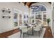 Bright dining room with a vaulted ceiling and large windows providing ample natural light and views of the surrounding nature at 2616 Boddie Pl, Duluth, GA 30097