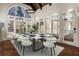 Bright dining room featuring hardwood floors, a modern chandelier, and large windows showcasing the beautiful outdoor views at 2616 Boddie Pl, Duluth, GA 30097