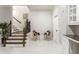 Bright entryway featuring a staircase, white walls, and colorful chairs at 2616 Boddie Pl, Duluth, GA 30097