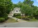 Elegant two-story home showcasing mature trees, a long driveway, and beautifully designed landscaping at 2616 Boddie Pl, Duluth, GA 30097