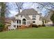 Stately home with a sunroom, large porch, manicured lawn, and tasteful landscaping at 2616 Boddie Pl, Duluth, GA 30097