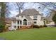 Stately home with a sunroom, large porch, manicured lawn, and tasteful landscaping at 2616 Boddie Pl, Duluth, GA 30097