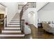 Grand foyer with winding staircase, hardwood floors, and views into the living room at 2616 Boddie Pl, Duluth, GA 30097