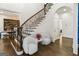 Beautiful foyer featuring hardwood floors, a staircase with wrought iron railing, and bright natural light at 2616 Boddie Pl, Duluth, GA 30097