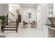 A bright entryway features a staircase and colorful accent chairs at 2616 Boddie Pl, Duluth, GA 30097
