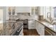This gourmet kitchen features stainless appliances, white cabinetry, and stone countertops at 2616 Boddie Pl, Duluth, GA 30097