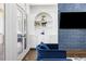 Close-up of the living space with a blue accent wall, a TV, and arched windows at 2616 Boddie Pl, Duluth, GA 30097