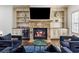 Cozy living room with fireplace, custom built-ins, and stylish seating, perfect for relaxation at 2616 Boddie Pl, Duluth, GA 30097
